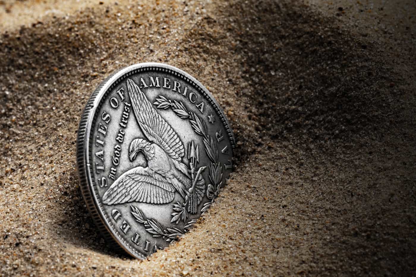 Shop Rare Coins - Morgan Silver Dollar in the sand